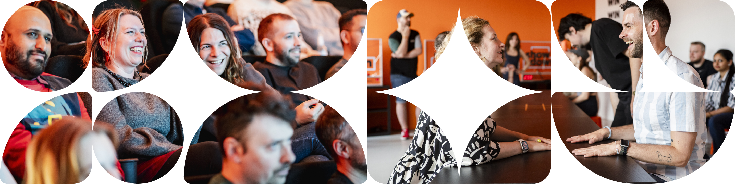 Group of diverse people smiling and engaging in a lively meeting or workshop setting.